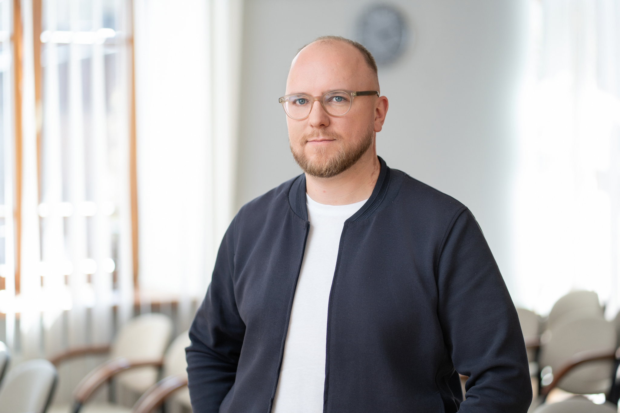 Portrait of Lukas Lukoševičius standing confidently in a bright interior